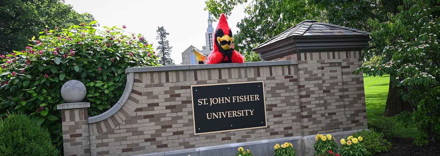 Cardinal mascot on brick sign of ϲַȫ Fisher University.